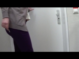 woman pees her purple pants in front of her home